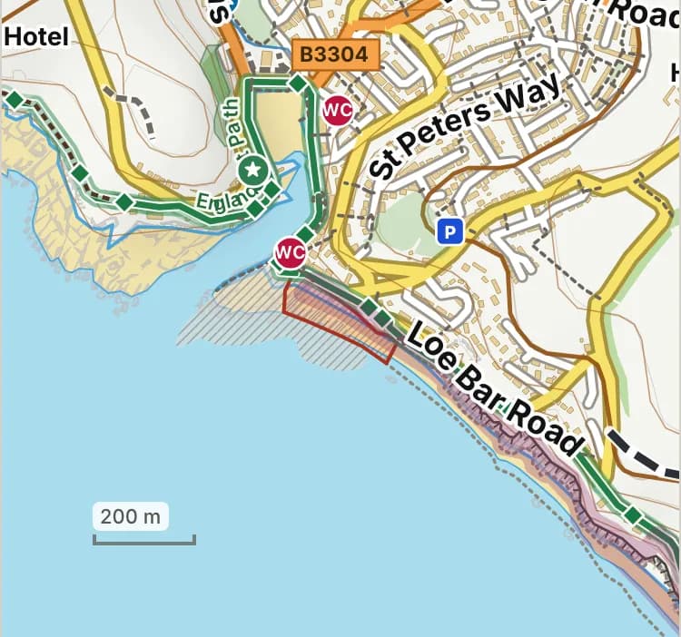 Map of Porthleven West: the stretch where dogs are banned 1 July to 31 August is hatched in brick. Beaches we have not placed an order on are outlined in grey dots, and say nothing about dogs.