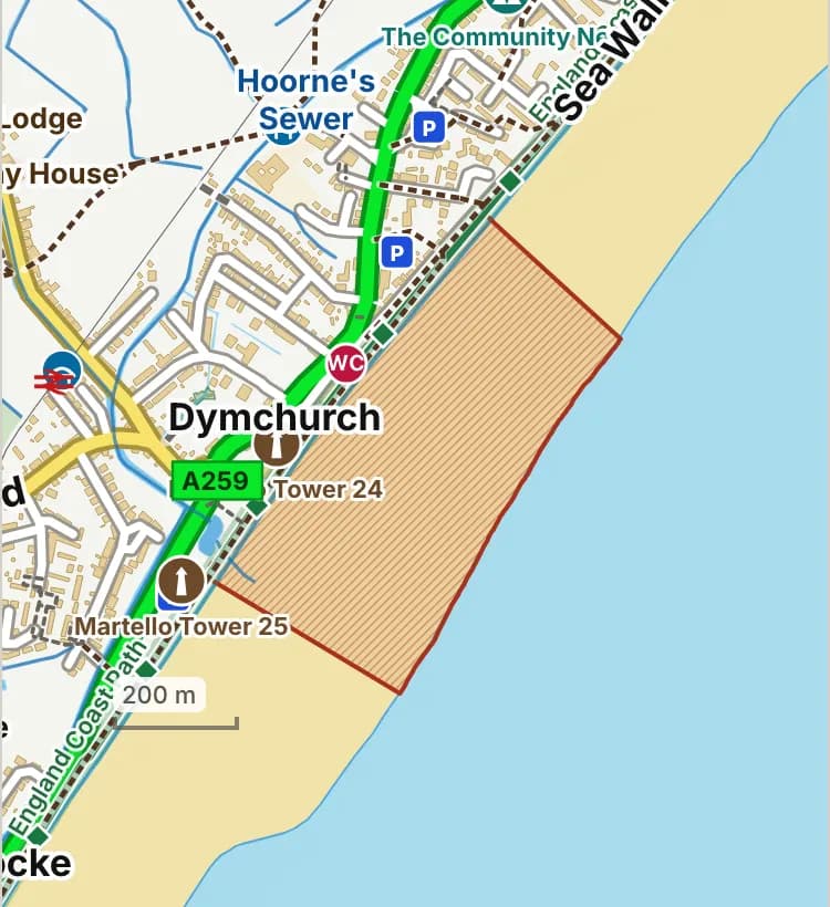 Map of Dymchurch beach: the stretch where dogs are banned 1 May to 30 September is hatched in brick, and the sea wall promenade, where dogs must be on a lead 1 May to 30 September, has a dashed brick edge.