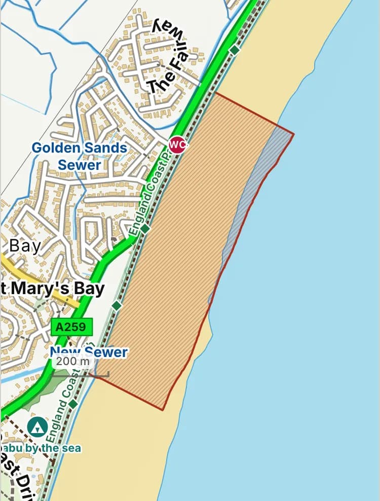 Map of St Mary’s Bay beach: the stretch where dogs are banned 1 May to 30 September is hatched in brick, and the promenade, where dogs must be on a lead 1 May to 30 September, has a dashed brick edge.