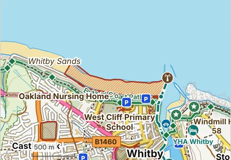 Map of West Beach: the stretch where dogs are banned 1 May to 30 September is hatched in brick, and the promenade, where dogs must be on a lead all year, has a dashed brick edge.